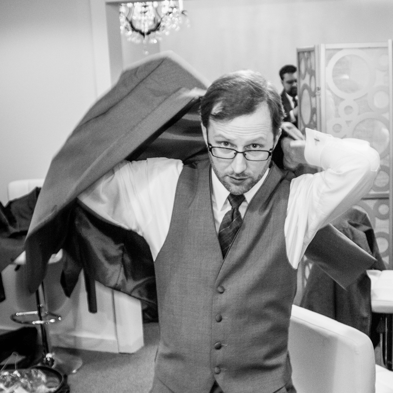 The author putting on a suit coat.