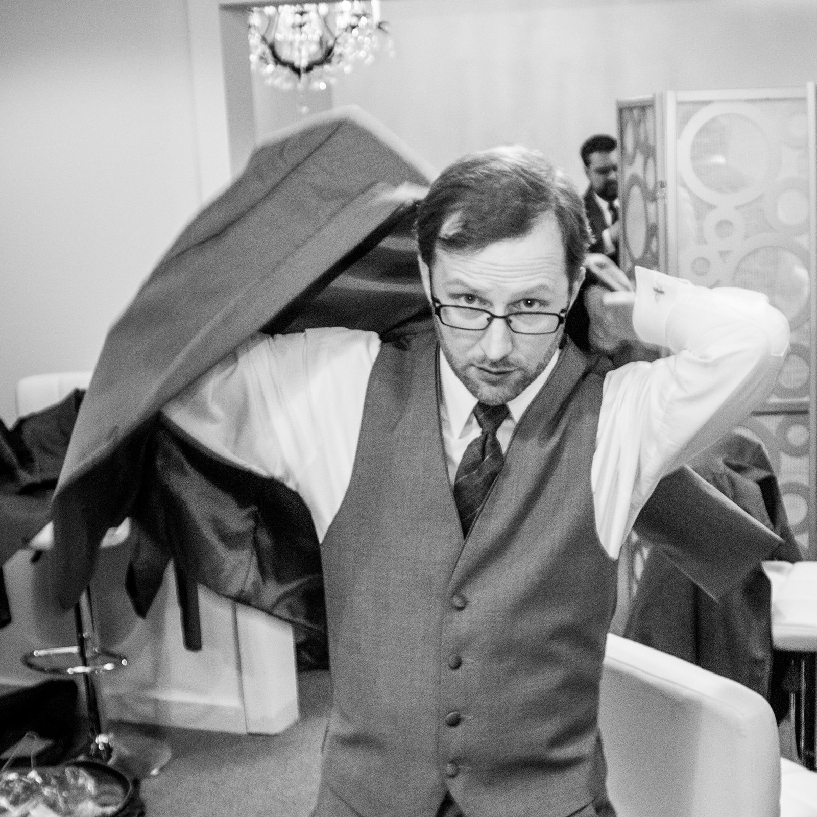 The author putting on a suit coat.