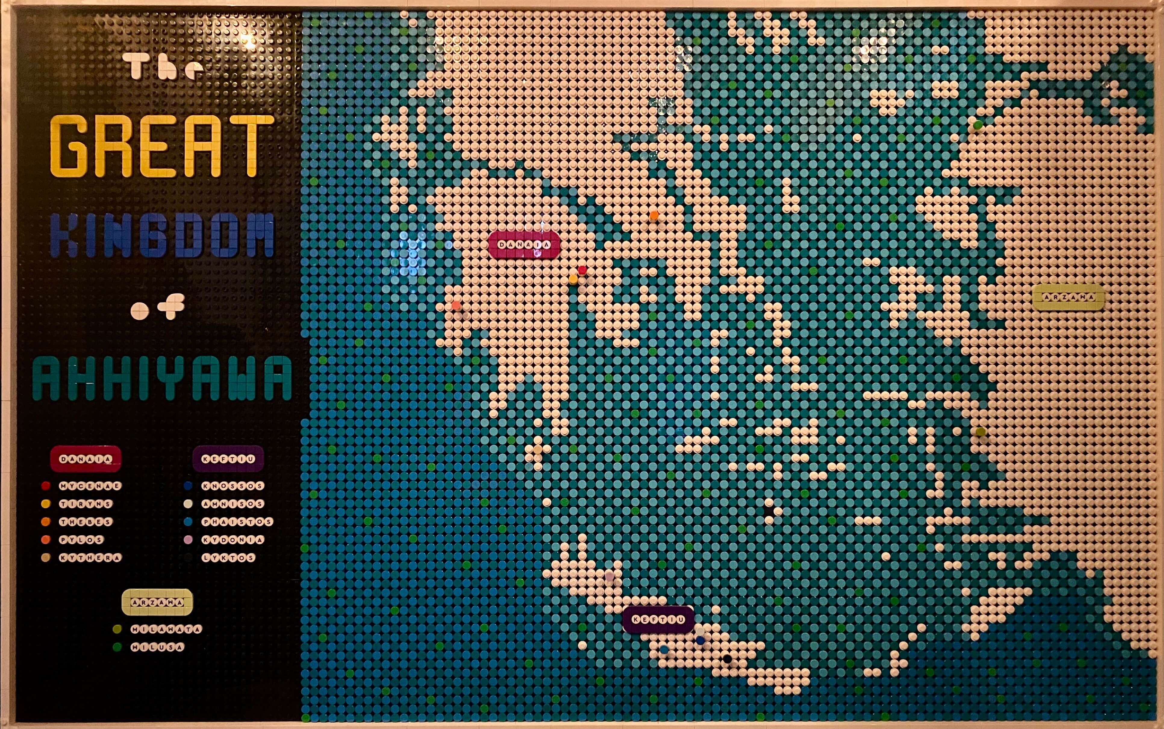 Lego Map of the Aegean with the title The Great Kingdo of Ahhiyawa. Below the title is a legend with three headers; Danaia, Keftiu, and Arzawa. Under the headers are place names with colored dots to the left of the name. On the map there are colored dots locating those places.