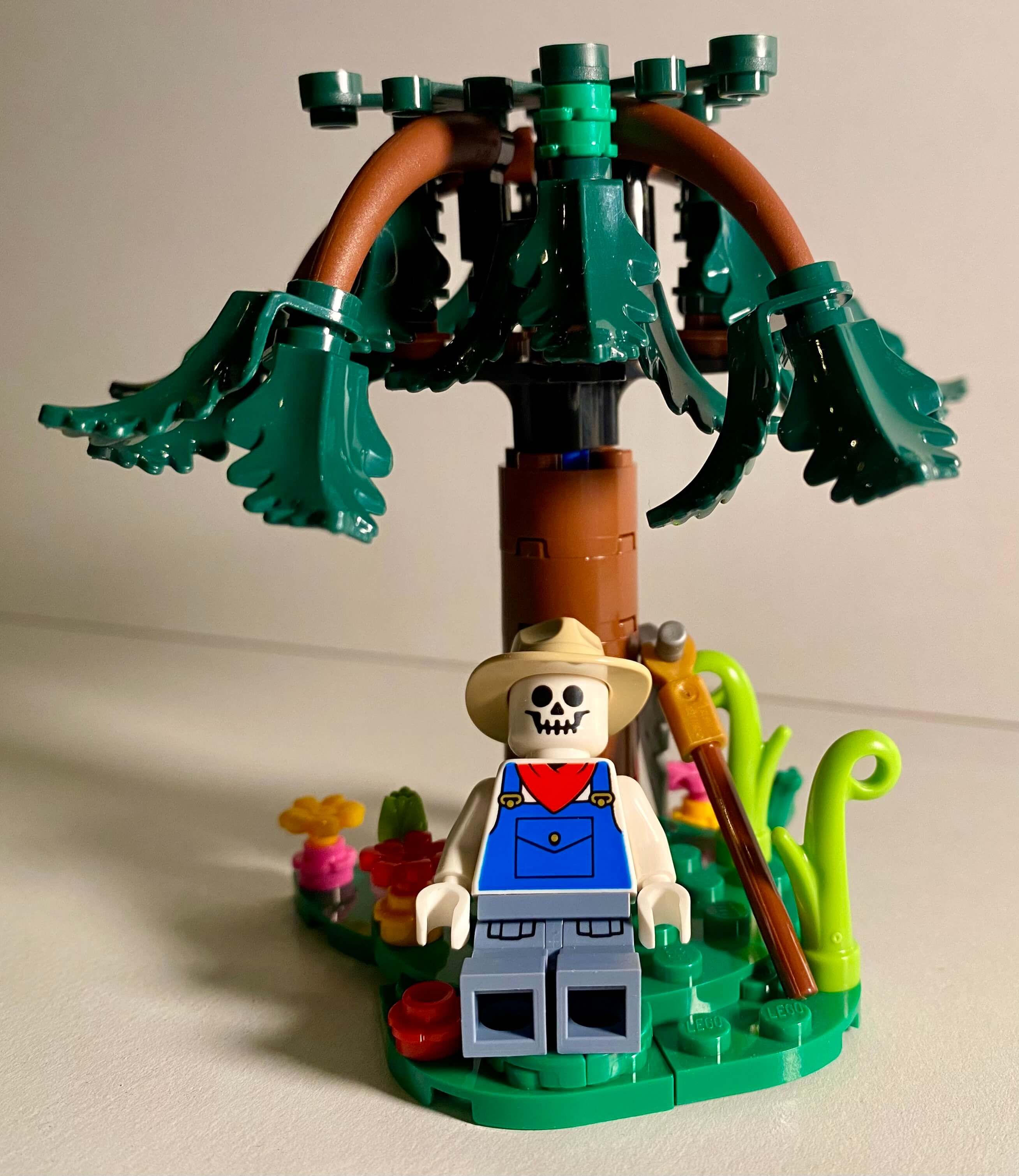 Lego of the cover of Reaper Man, Death lounges beneath a tree.